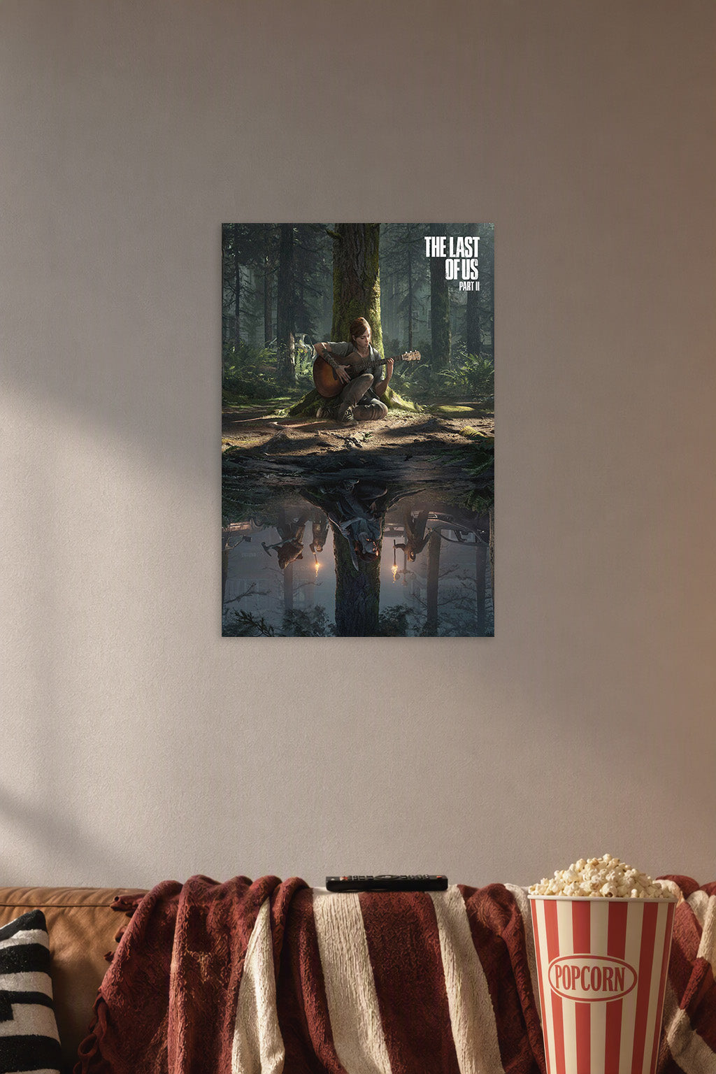 Ellie The Last of Us Part II in a cozy movie room above a brown sofa with popcorn.