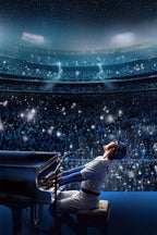 Elton John Rocketman concert poster depicts a singer at a black piano before a vast blue-lit stadium crowd beneath stars.