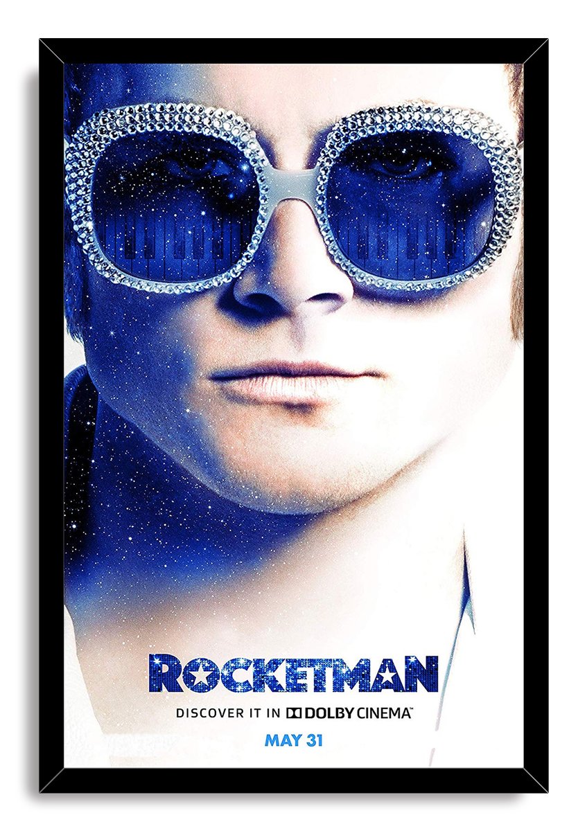 Rocketman framed wall art print with a black border, Elton John close-up, jeweled sunglasses, and cosmic piano reflections.