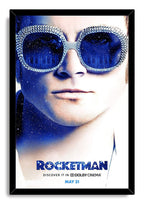 Rocketman framed wall art print with a black border, Elton John close-up, jeweled sunglasses, and cosmic piano reflections.