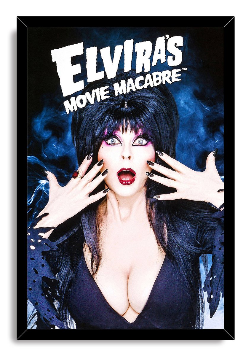 Elvira's Movie Macabre framed wall art print depicts Elvira’s startled gaze, dark hair and outstretched hands beneath bold white lettering.