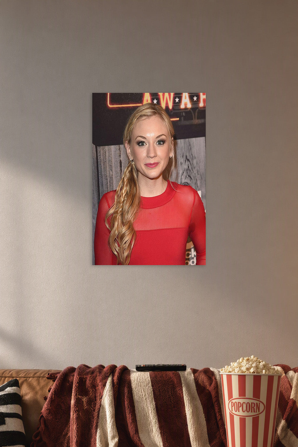 Emily Kinney in a cozy movie room above a brown sofa with popcorn.