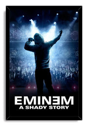 Eminem framed wall art print portrays a hooded performer holding a microphone above a cheering concert crowd, illuminated by blue stage lights.