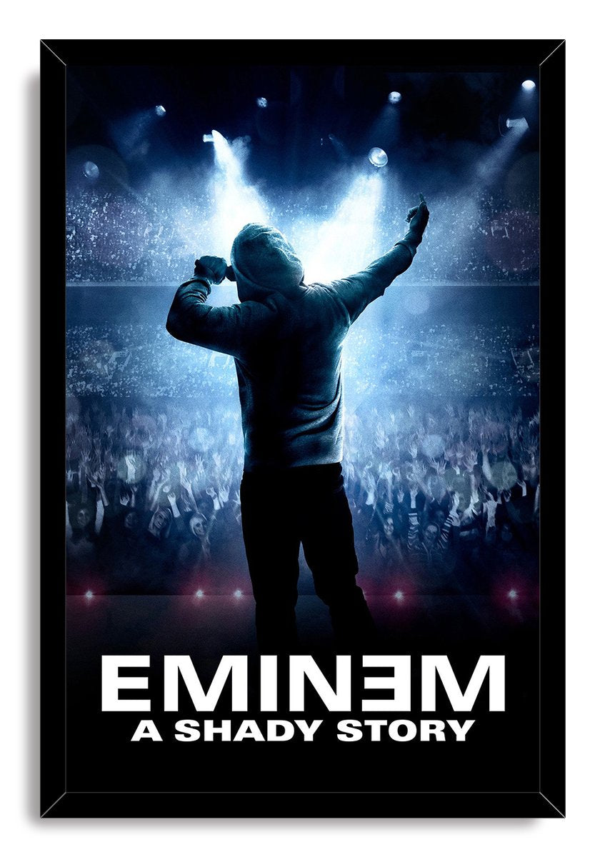 Eminem framed wall art print portrays a hooded performer holding a microphone above a cheering concert crowd, illuminated by blue stage lights.
