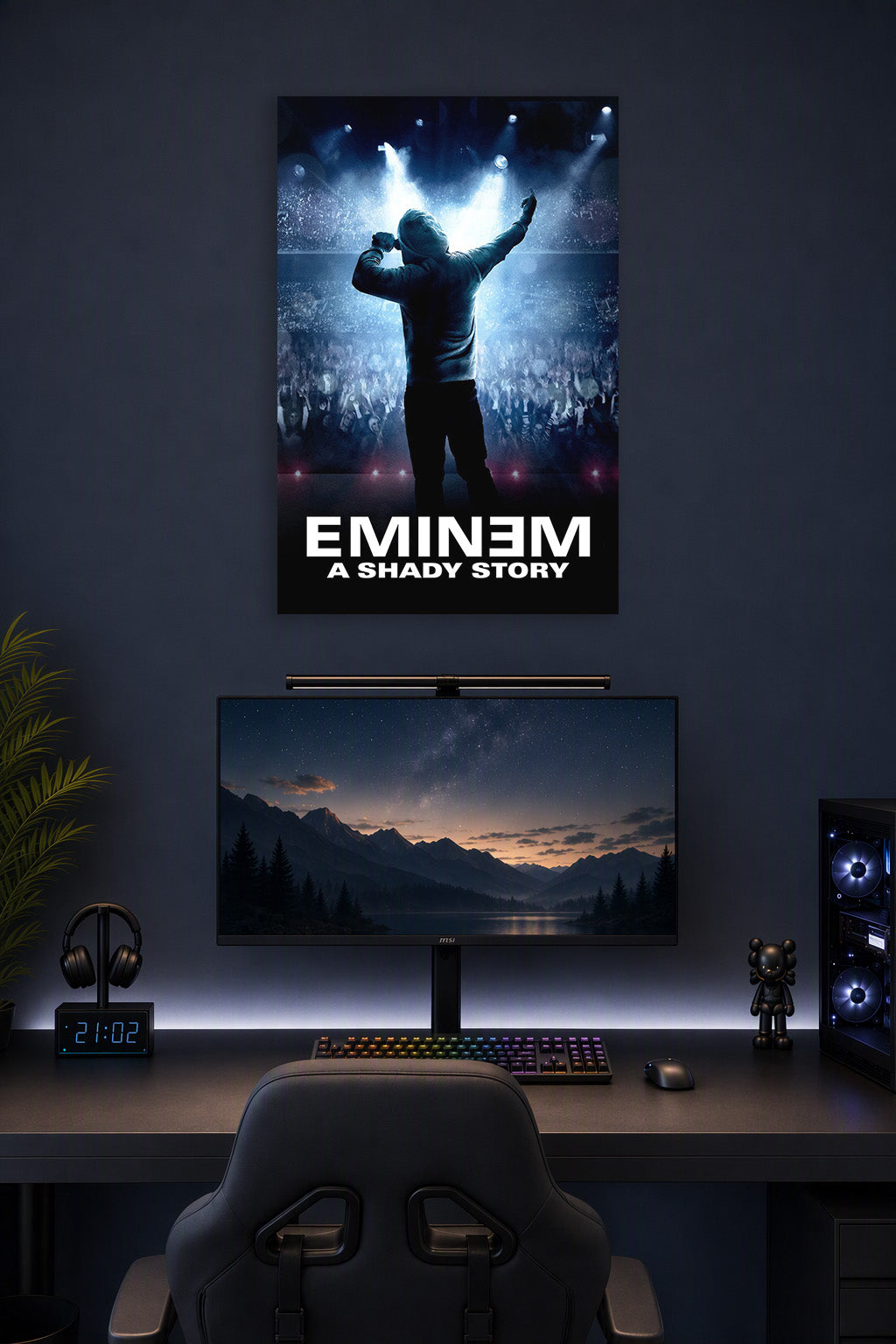 Eminem in a gaming desk setup above a monitor.