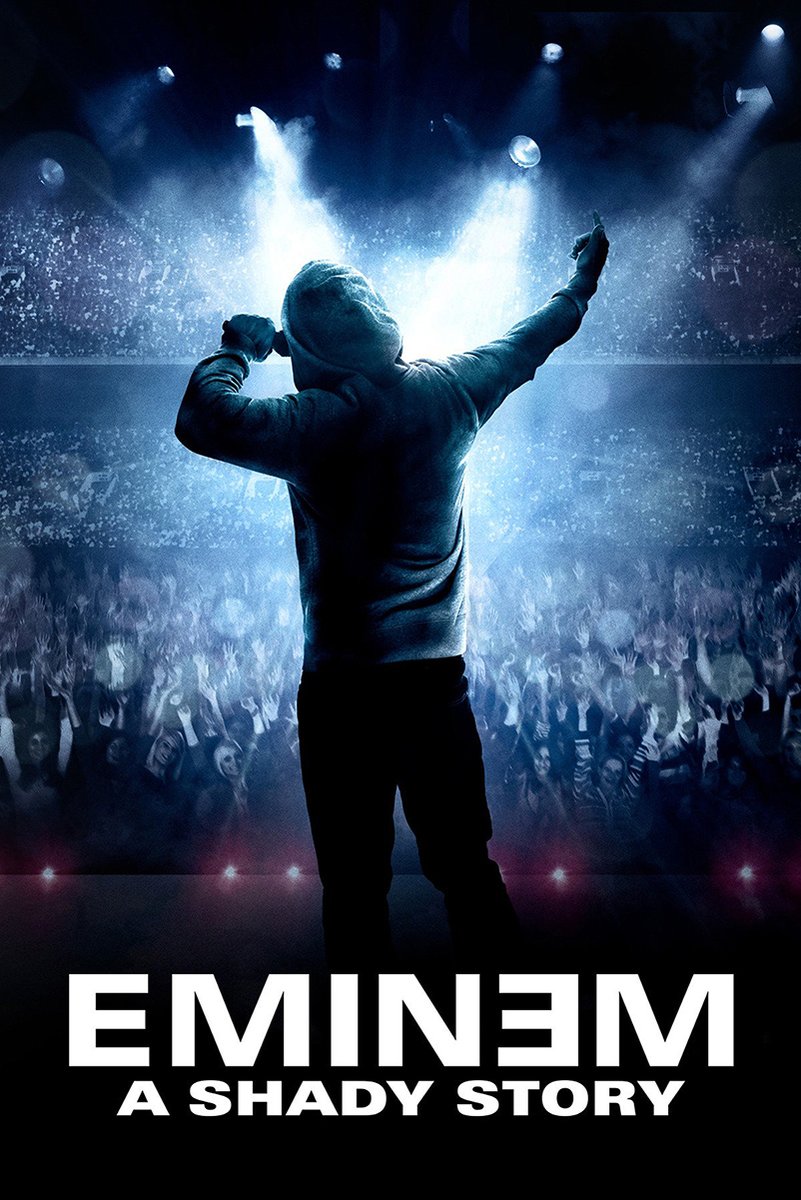 Eminem poster features a hooded performer with microphone raised before a cheering crowd under dramatic blue spotlights and bold white title text.