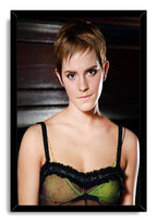 Emma Watson framed wall art print presents a short-haired portrait in a black frame, with a green and black top and dark background.