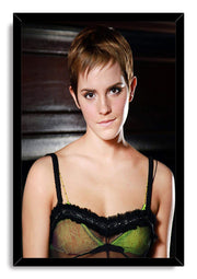 Emma Watson framed wall art print presents a short-haired portrait in a black frame, with a green and black top and dark background.