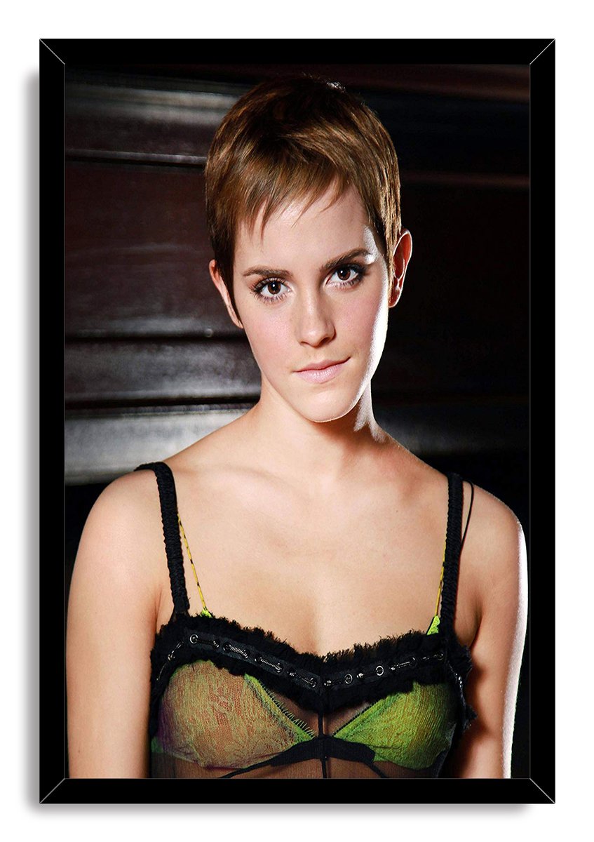 Emma Watson framed wall art print presents a short-haired portrait in a black frame, with a green and black top and dark background.