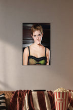 Emma Watson in a cozy movie room above a brown sofa with popcorn.
