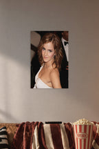 Emma Watson in a cozy movie room above a brown sofa with popcorn.