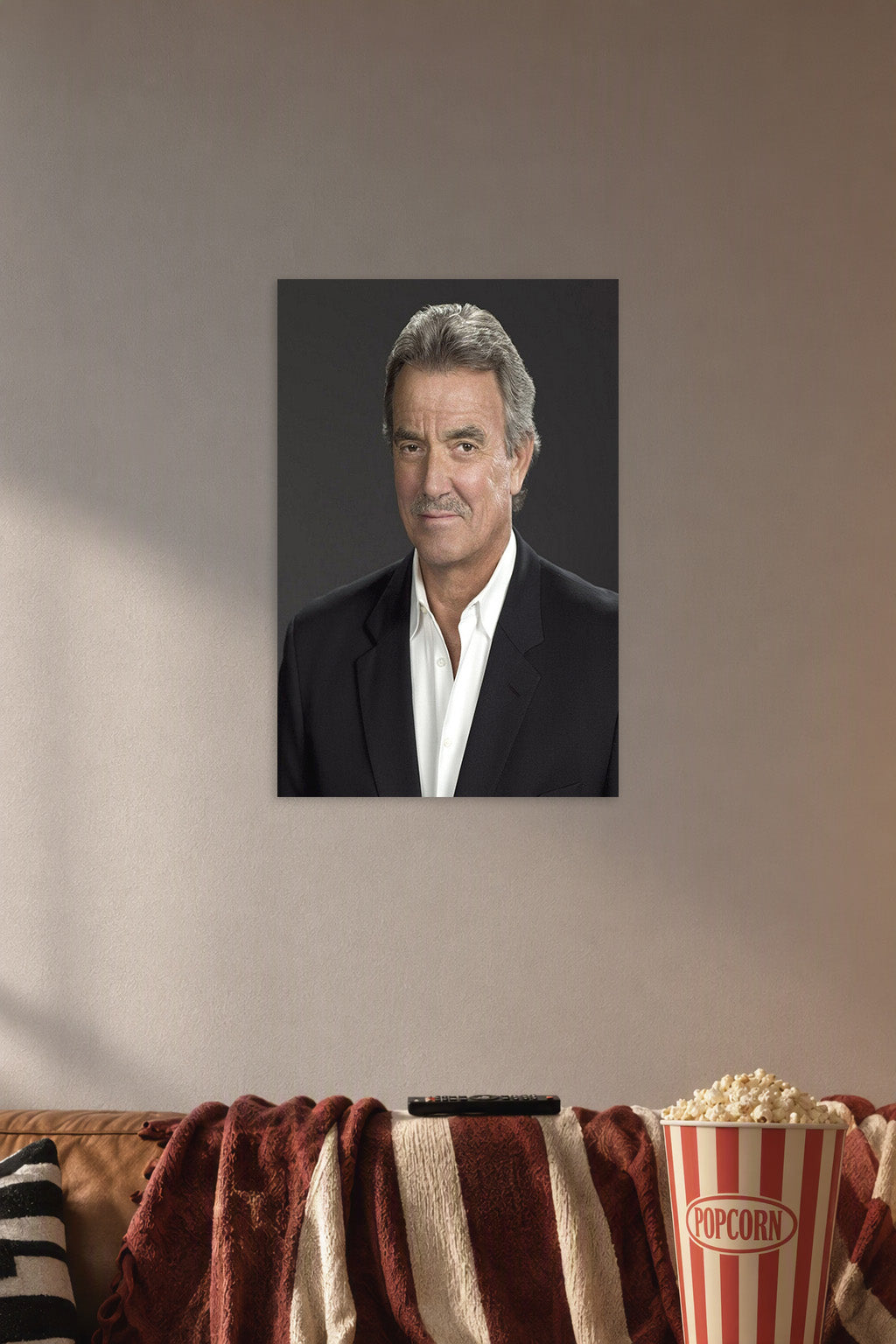 Eric Braeden in a cozy movie room above a brown sofa with popcorn.