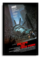 Escape from New York wall art print in a black frame depicts a fallen Statue of Liberty head and figures running through Manhattan.