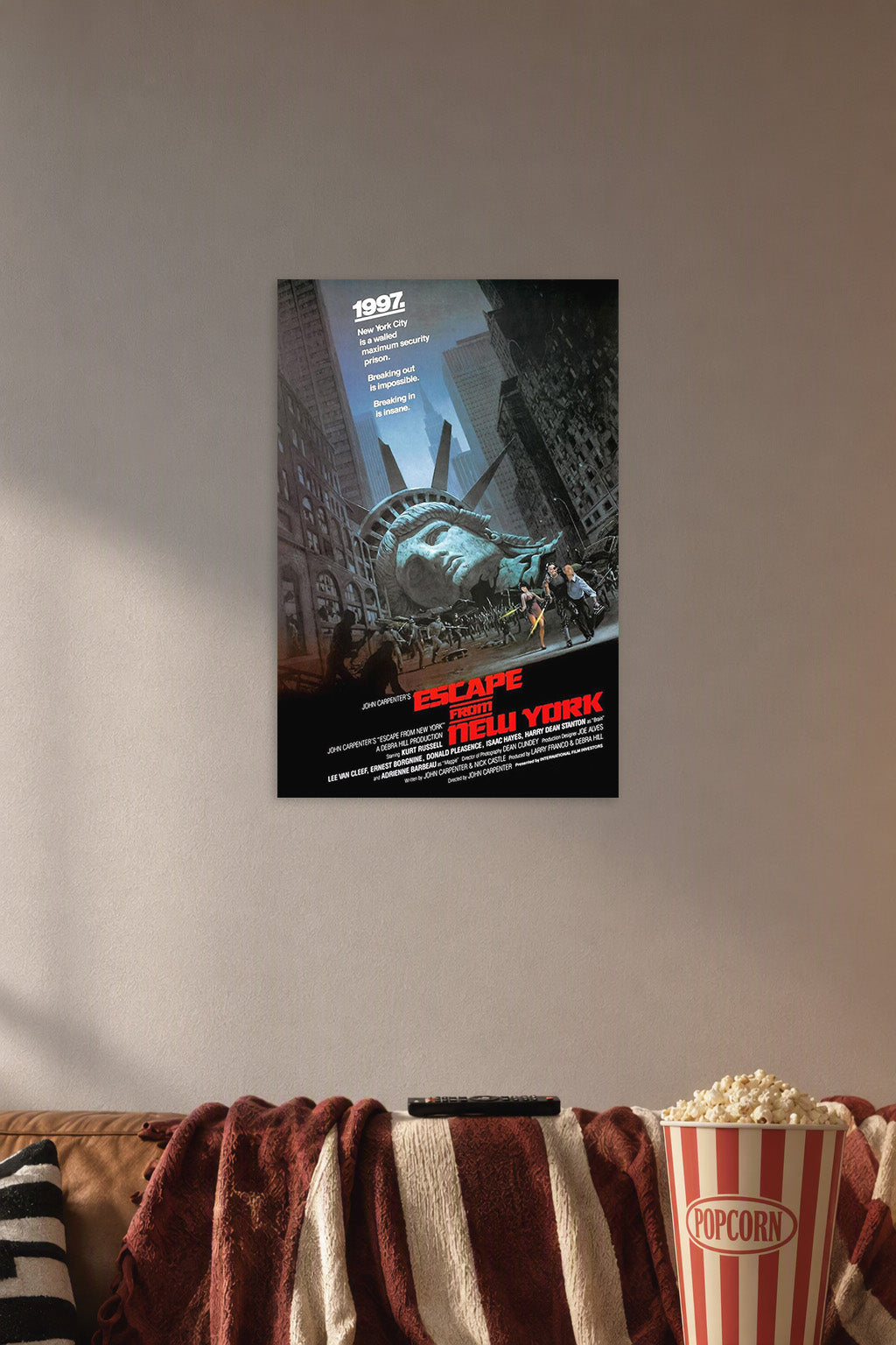 Escape From New York Movie Poster in a cozy movie room above a brown sofa with popcorn.