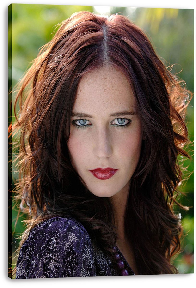 Eva Green canvas wall art print displays her close-up portrait with wavy auburn hair, red lipstick, and a softly blurred green backdrop.
