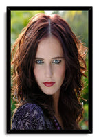 Eva Green framed wall art print features a direct portrait with dark auburn curls, blue eyes, red lips, and a glossy black frame.