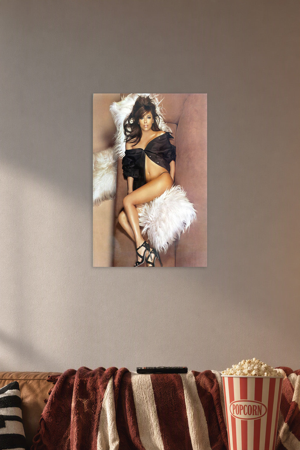 Eva Longoria in a cozy movie room above a brown sofa with popcorn.