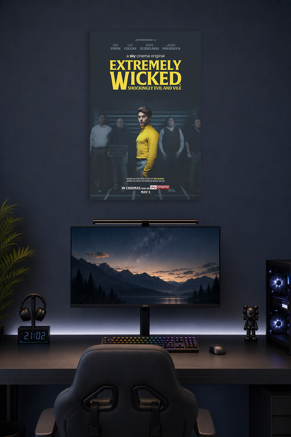 Extremely Wicked, Shockingly Evil and Vile Movie Zac Efron Ted Bundy in a gaming desk setup above a monitor.