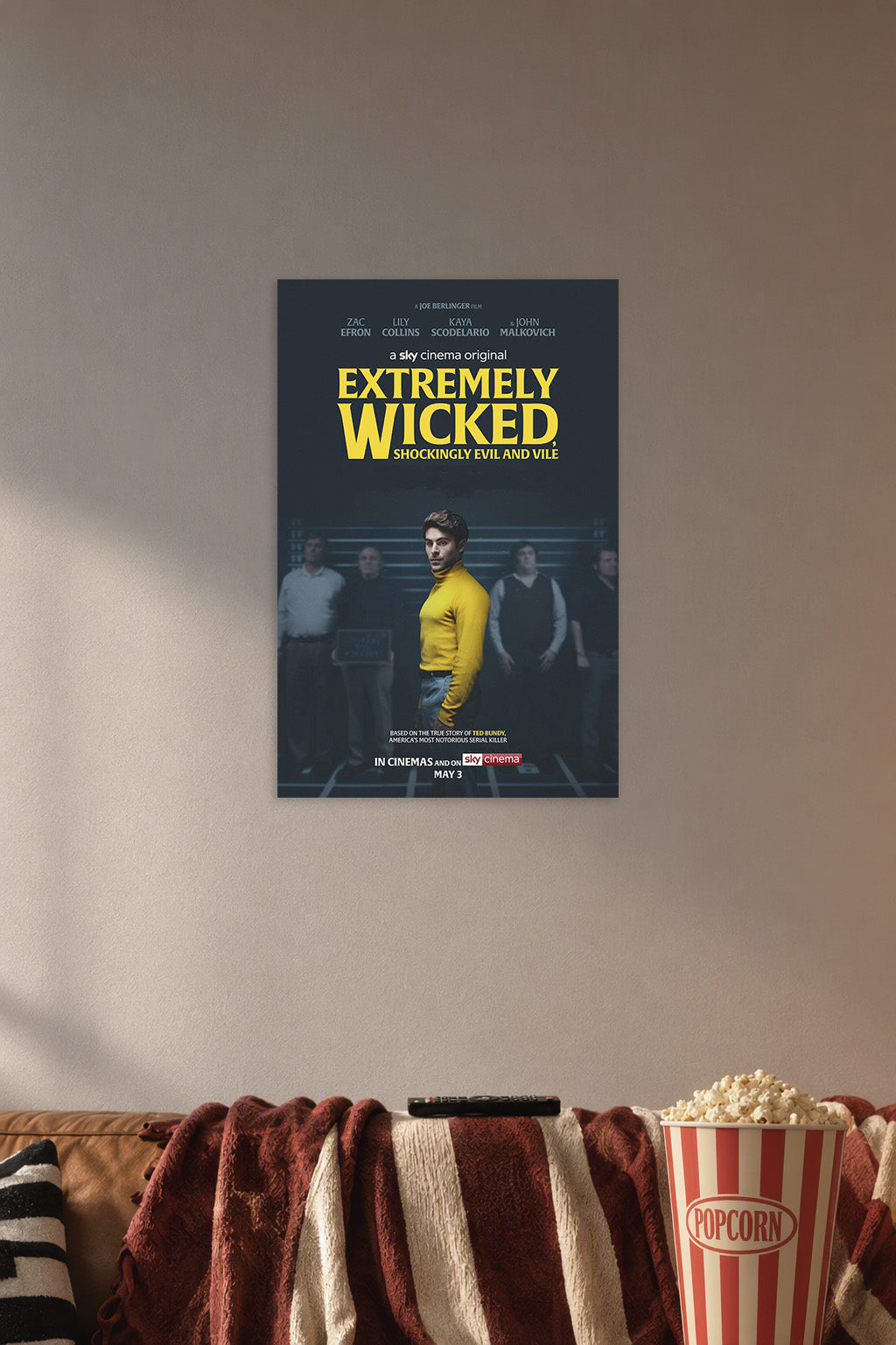 Extremely Wicked, Shockingly Evil and Vile Movie Zac Efron Ted Bundy in a cozy movie room above a brown sofa with popcorn.