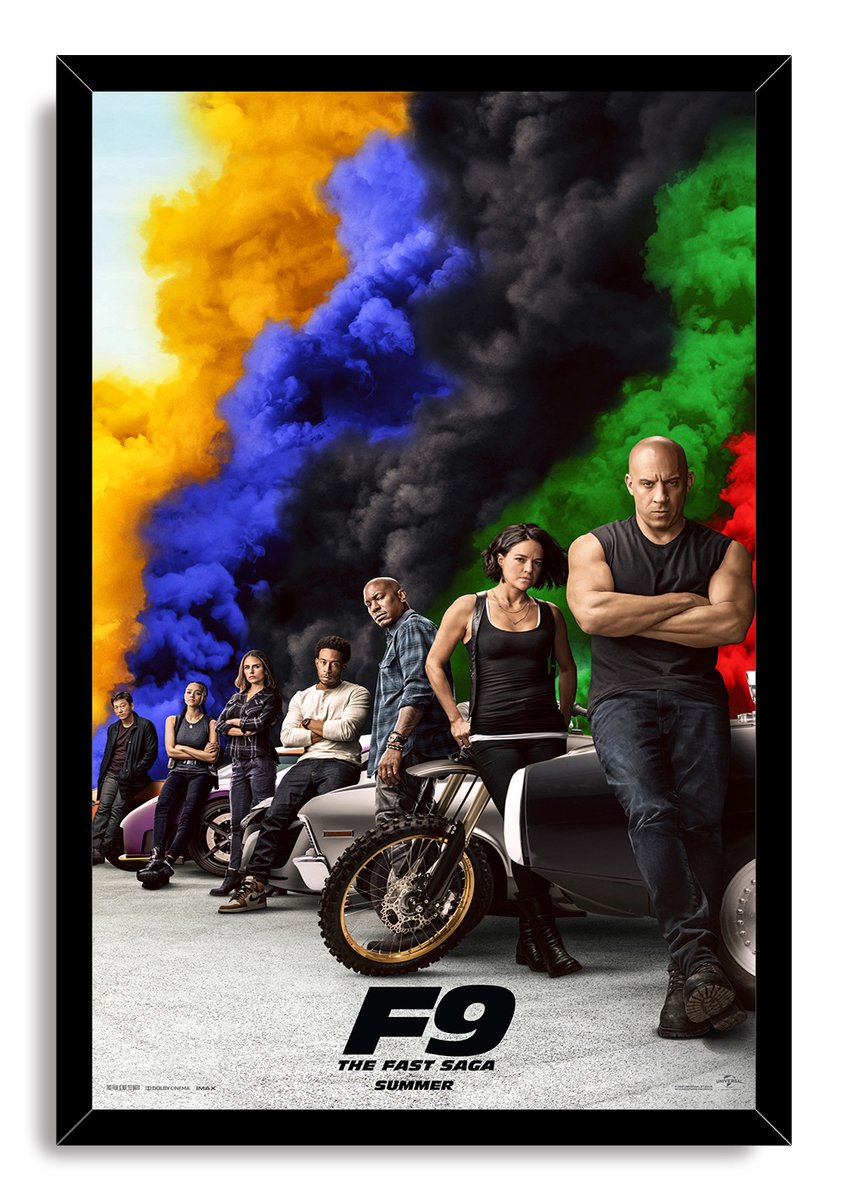 F9 The Fast Saga framed wall art print featuring the cast posed with vehicles below bold yellow, blue, black, green, and red smoke.