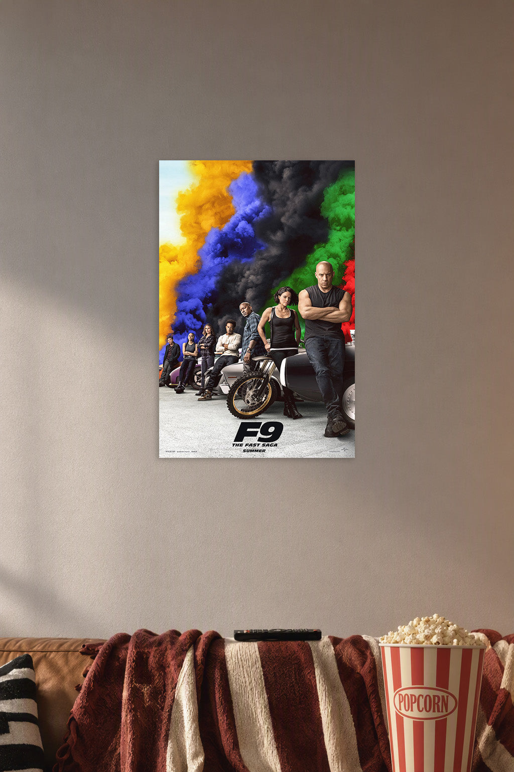 F9 The Fast Saga Movie Cast in a cozy movie room above a brown sofa with popcorn.