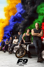 F9 The Fast Saga poster featuring the cast beside cars and a motorcycle beneath yellow, blue, black, green, and red smoke.