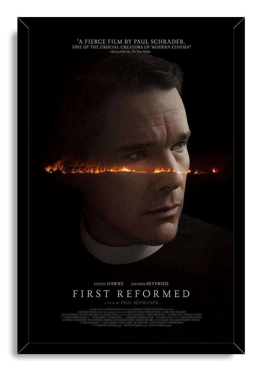 First Reformed framed poster presents Ethan Hawke's priest portrait with a glowing wildfire horizon, black border, and white background.
