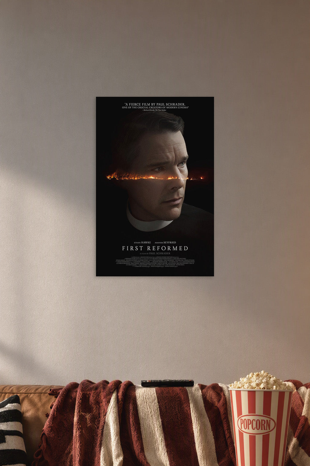 First Reformed Ethan Hawke in a cozy movie room above a brown sofa with popcorn.