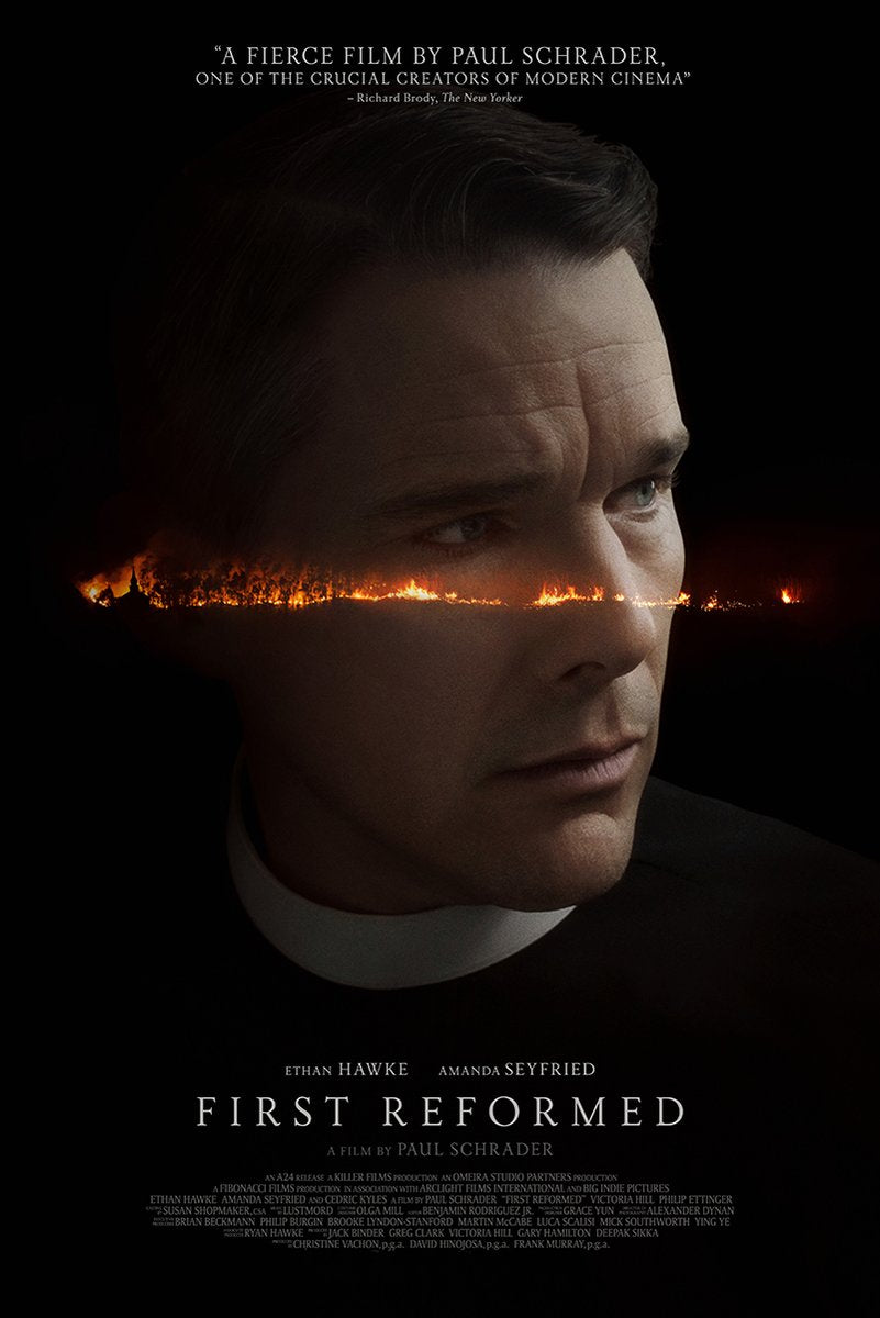 First Reformed poster features Ethan Hawke as a solemn priest, with a burning orange horizon crossing his face on black.