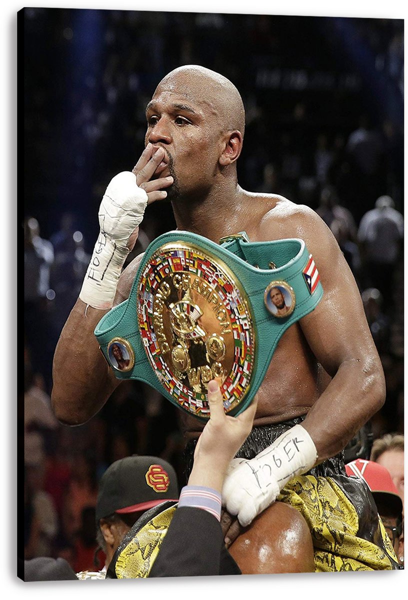 Floyd Mayweather canvas wall art print features the boxer with wrapped hands and a green gold championship belt against a dark arena crowd.