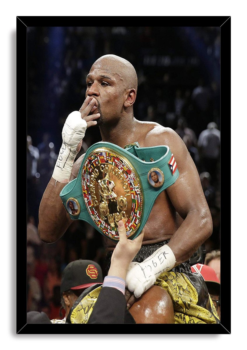Floyd Mayweather framed wall art print portrays the boxer holding a championship belt as he blows a kiss amid spectators.