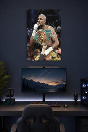 Floyd Mayweather in a gaming desk setup above a monitor.