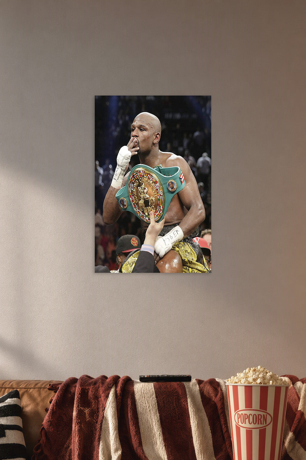 Floyd Mayweather in a cozy movie room above a brown sofa with popcorn.