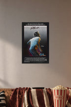 Footloose Movie in a cozy movie room above a brown sofa with popcorn.