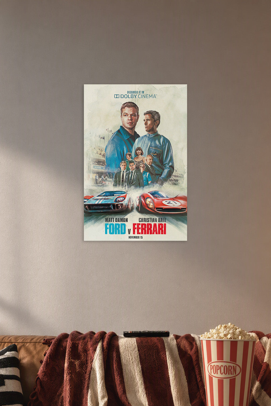 Ford v Ferrari Movie Poster in a cozy movie room above a brown sofa with popcorn.