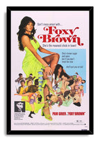 Foxy Brown framed wall art print featuring Pam Grier in a lime green dress, red typography, and a vibrant character collage.