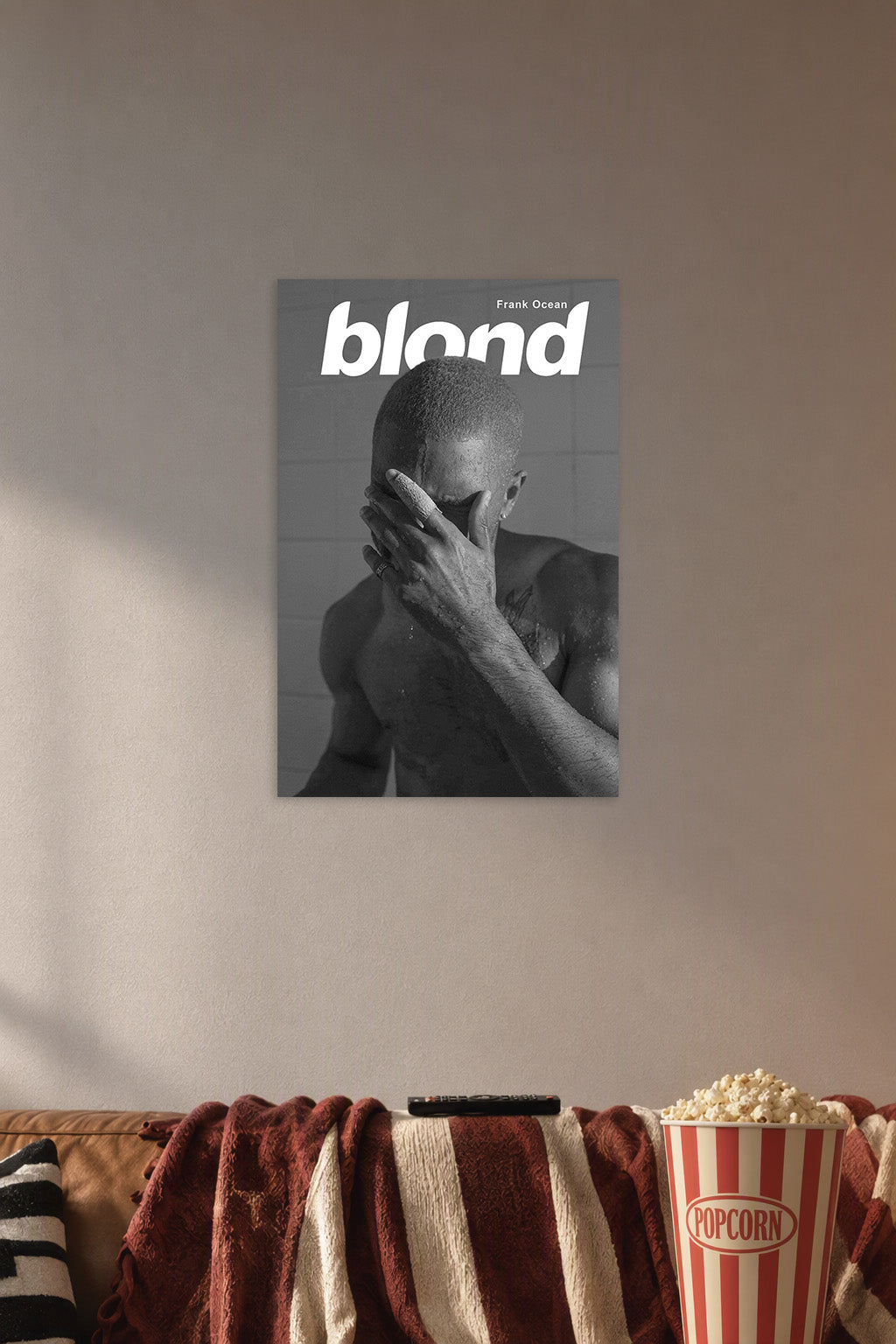 Frank Ocean Blond Album Cover in a cozy movie room above a brown sofa with popcorn.