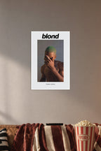 Frank Ocean Blond Album Cover in a cozy movie room above a brown sofa with popcorn.