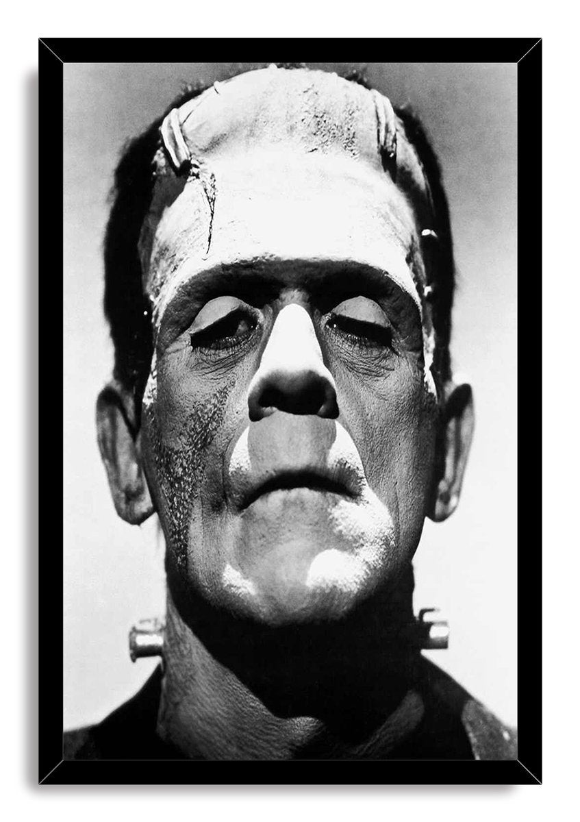 Frankenstein's Monster framed wall art print displays a black-and-white close-up portrait of the creature inside a slim black frame.