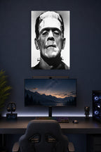 Frankenstein's Monster in a gaming desk setup above a monitor.