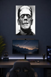 Frankenstein's Monster in a gaming desk setup above a monitor.