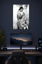 Freddie Mercury in a gaming desk setup above a monitor.