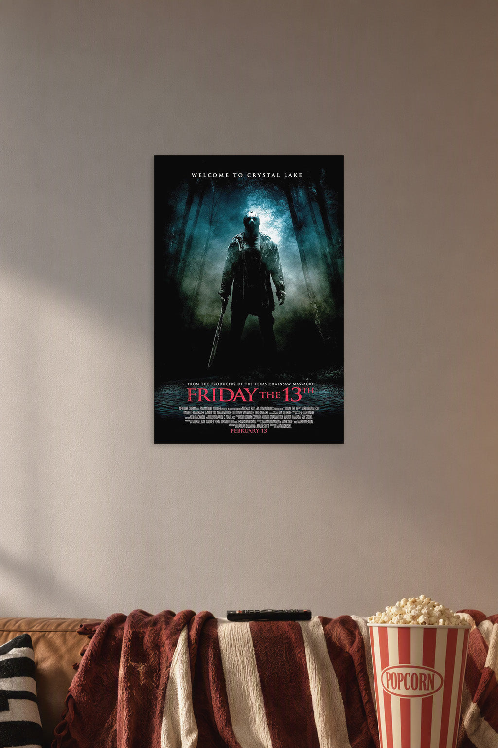 Friday the 13th Jason Voorhees in a cozy movie room above a brown sofa with popcorn.