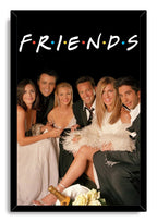 Friends framed wall art print featuring the cast in formal attire, with the logo, champagne bottle, and white roses.