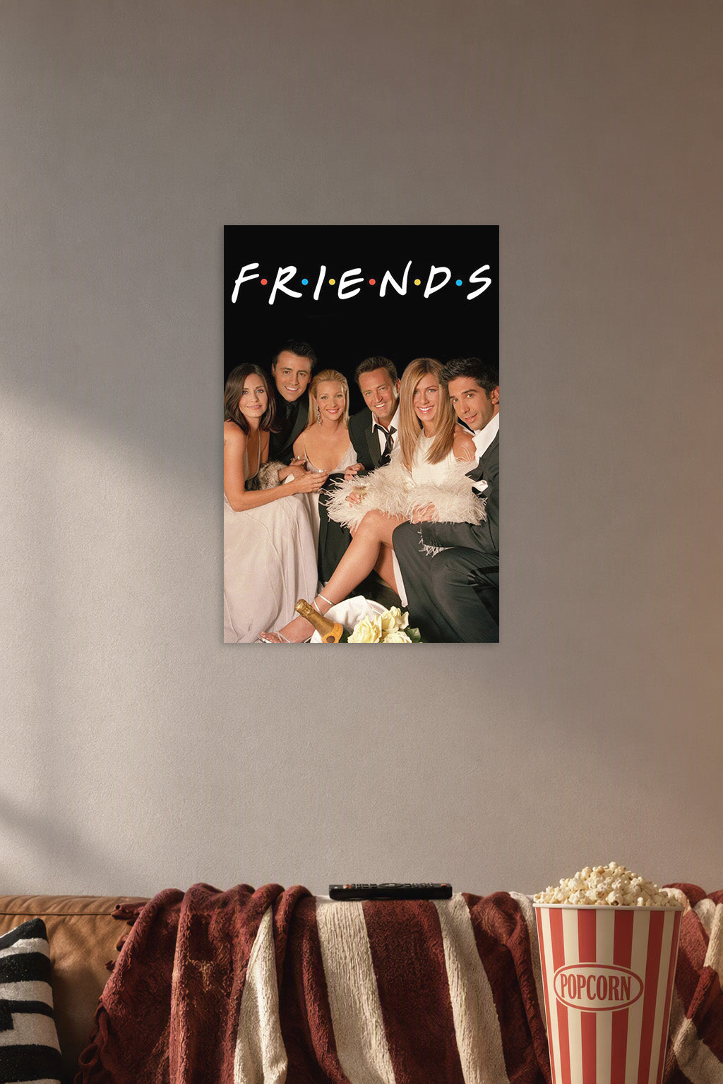 Friends TV Show Cast in a cozy movie room above a brown sofa with popcorn.