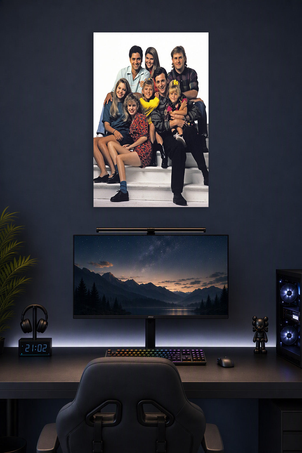 Full House Cast Family in a gaming desk setup above a monitor.