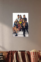 Full House Cast Family in a cozy movie room above a brown sofa with popcorn.
