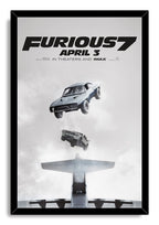Furious 7 framed wall art print presents two cars dropping from above an airplane against a soft gray cloudscape in a black frame.