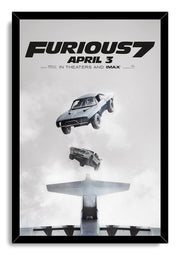 Furious 7 framed wall art print presents two cars dropping from above an airplane against a soft gray cloudscape in a black frame.
