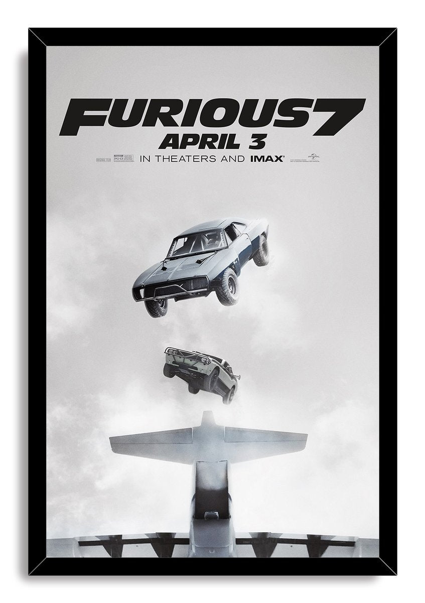 Furious 7 framed wall art print presents two cars dropping from above an airplane against a soft gray cloudscape in a black frame.